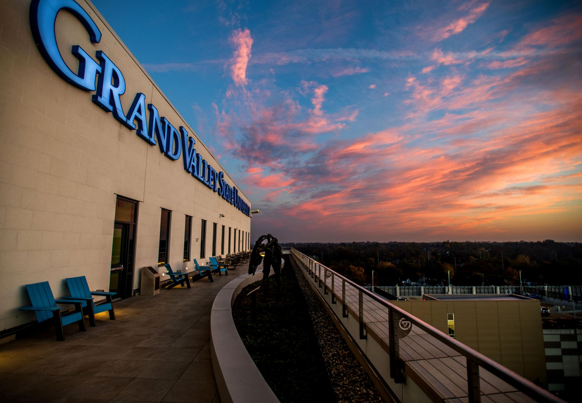 Grand Valley State University Sign on the Health Campus roof with sunrise